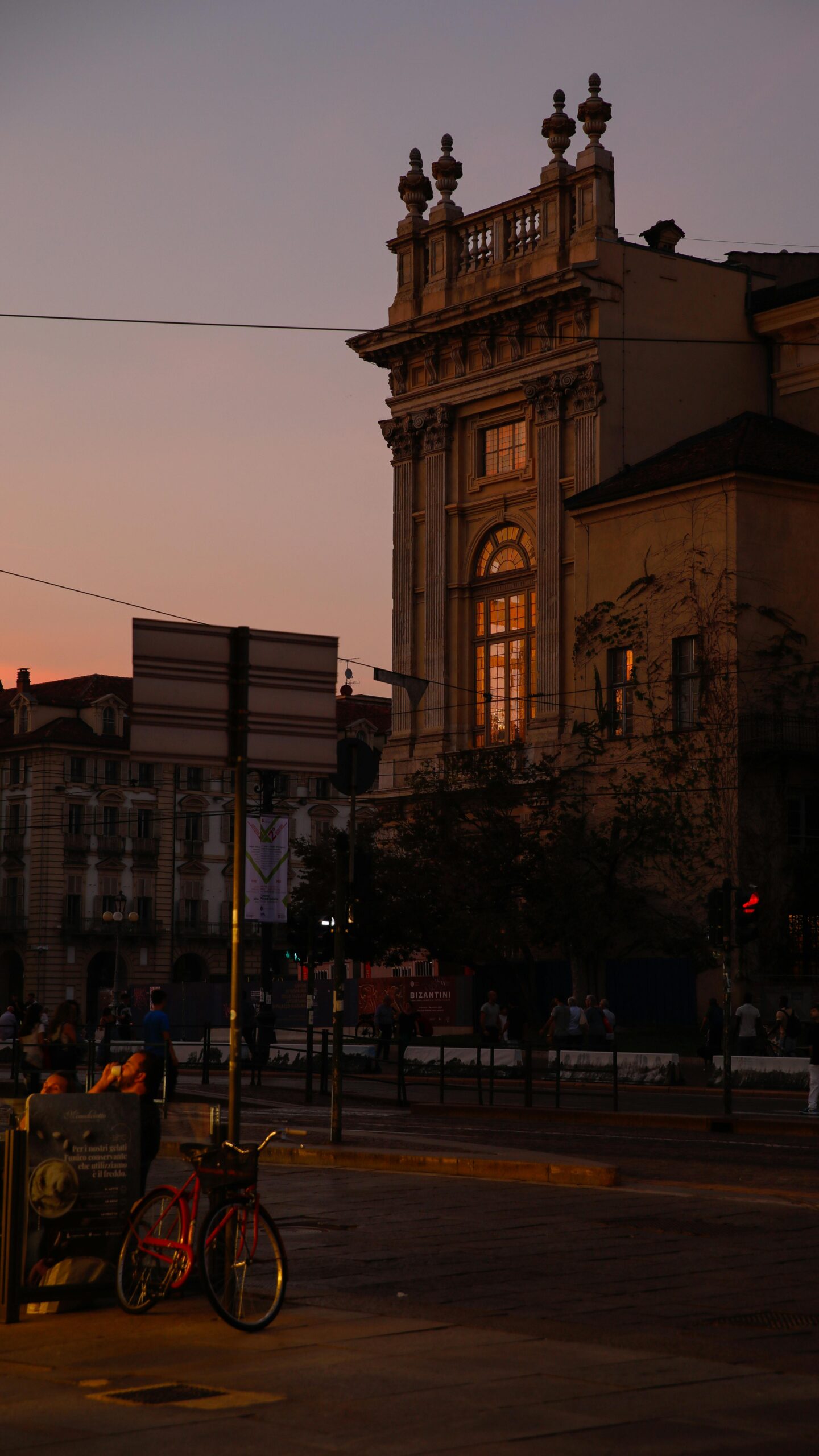 Vintage architecture under twilight skies in Torino, Italy's city streets.